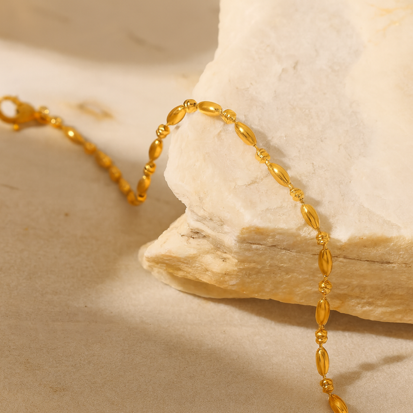Gold bracelet on a stone surface