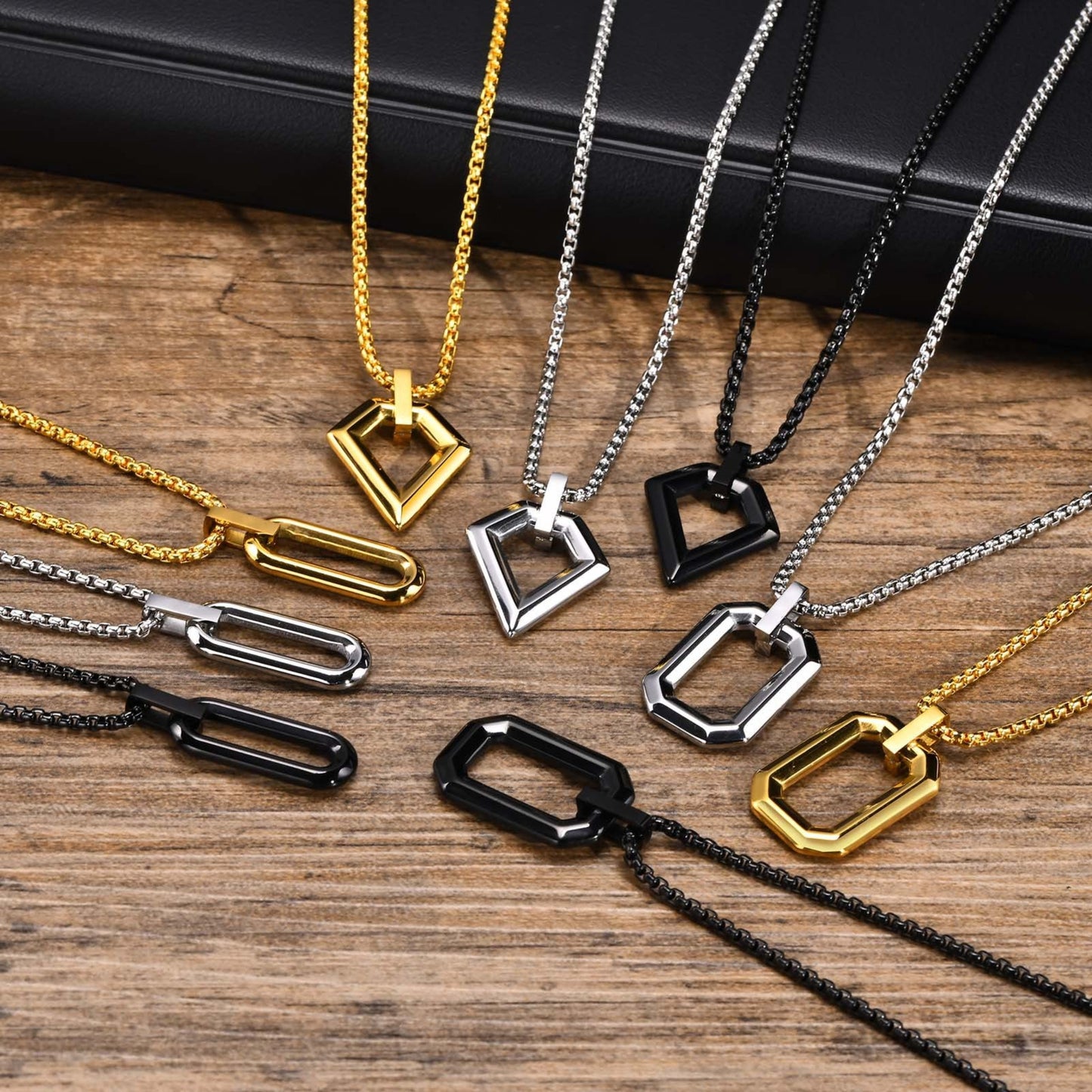 Collection of gold, silver, and black necklaces on a wooden surface