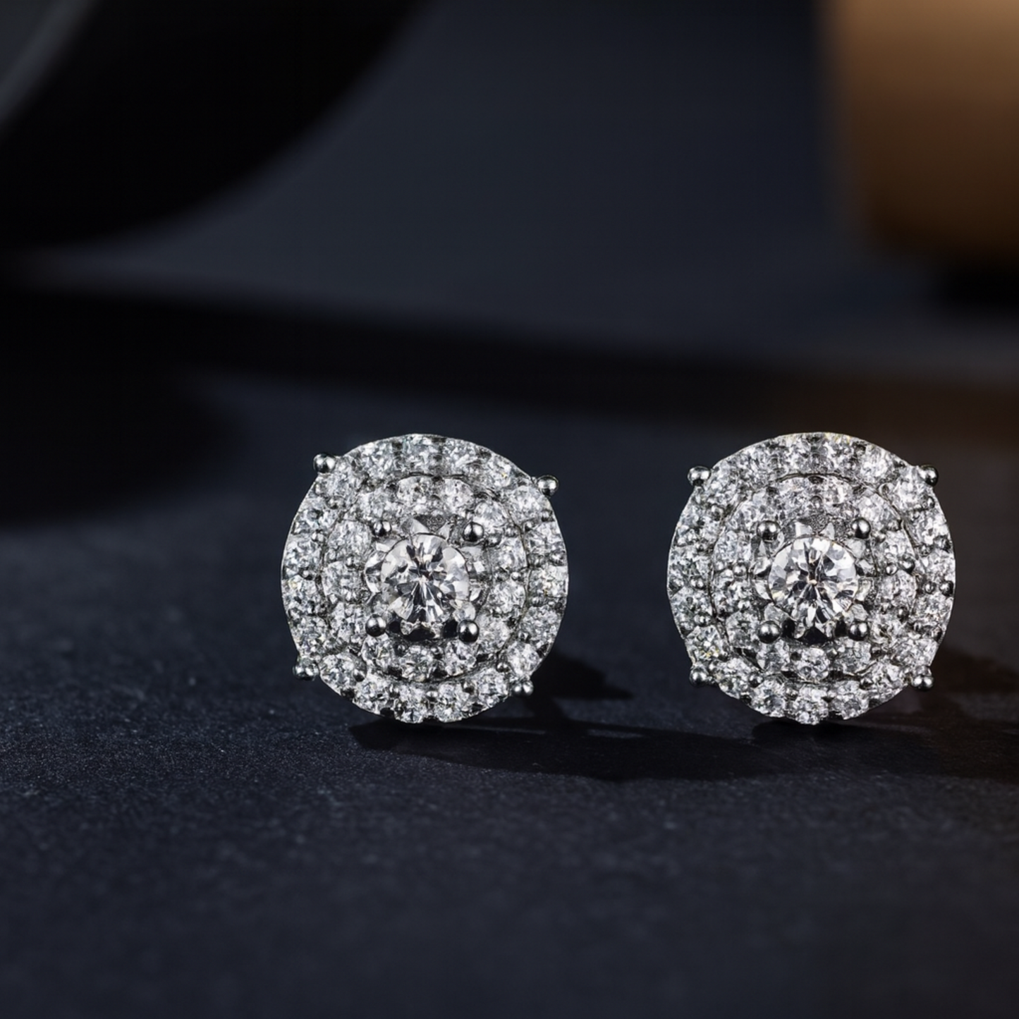 Pair of diamond earrings on a dark background