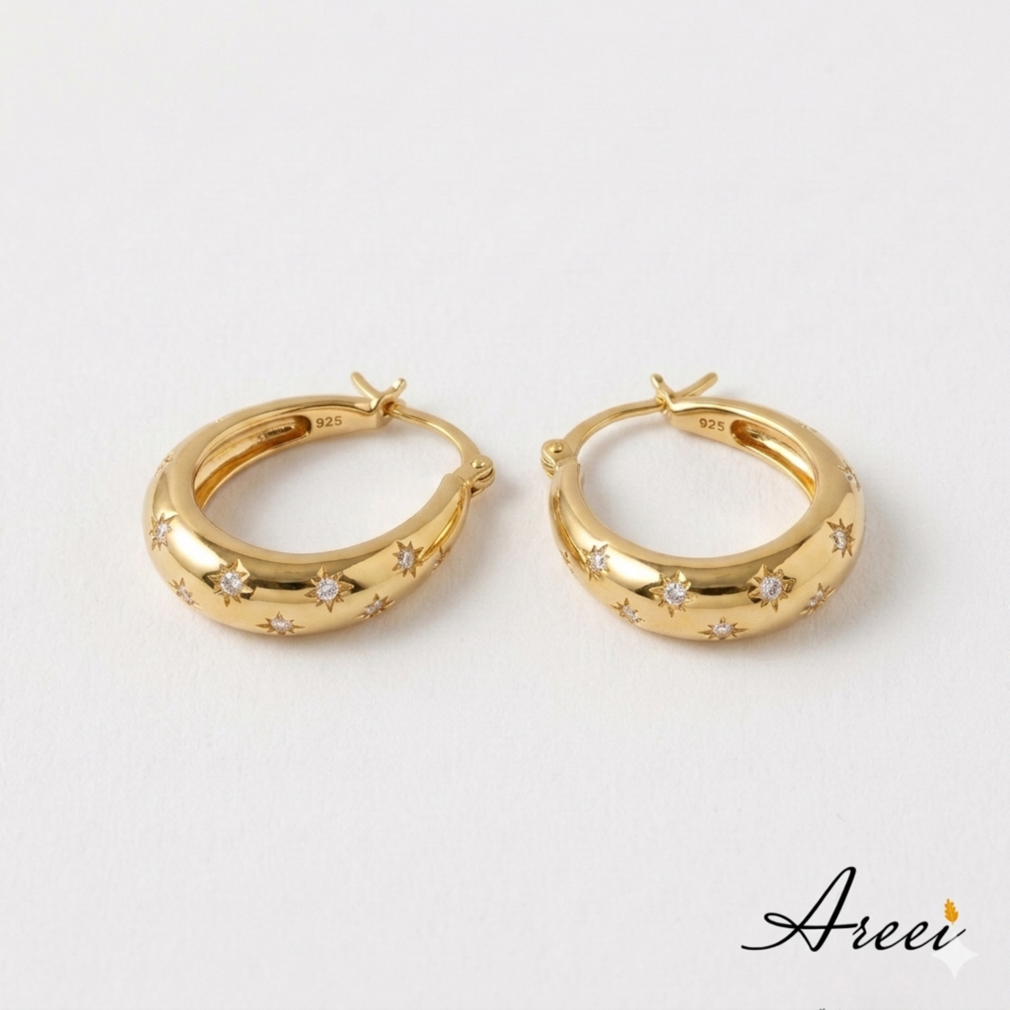 Gold hoop earrings with star designs on a white background, featuring the brand 'Areei'.