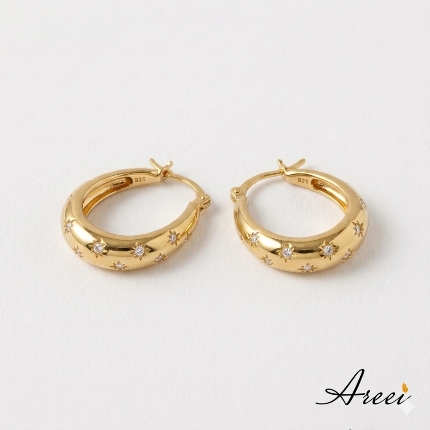 Gold hoop earrings with star designs on a white background, featuring the brand 'Areei'.
