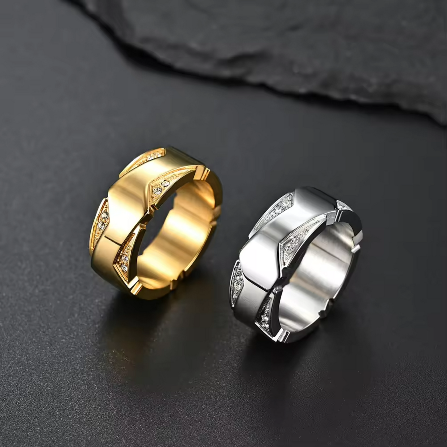 Gold and silver rings on a dark surface