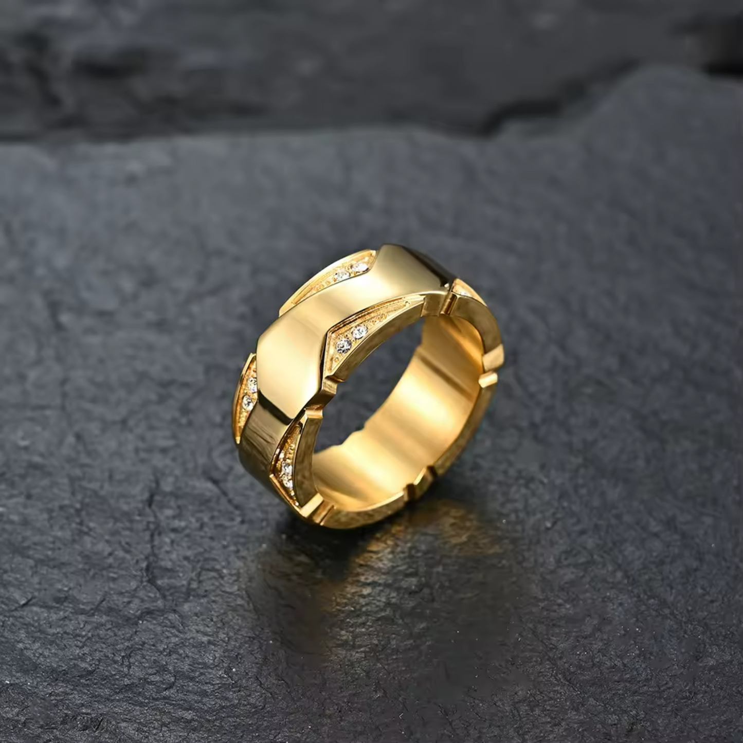 Gold ring with diamond accents on a dark stone surface