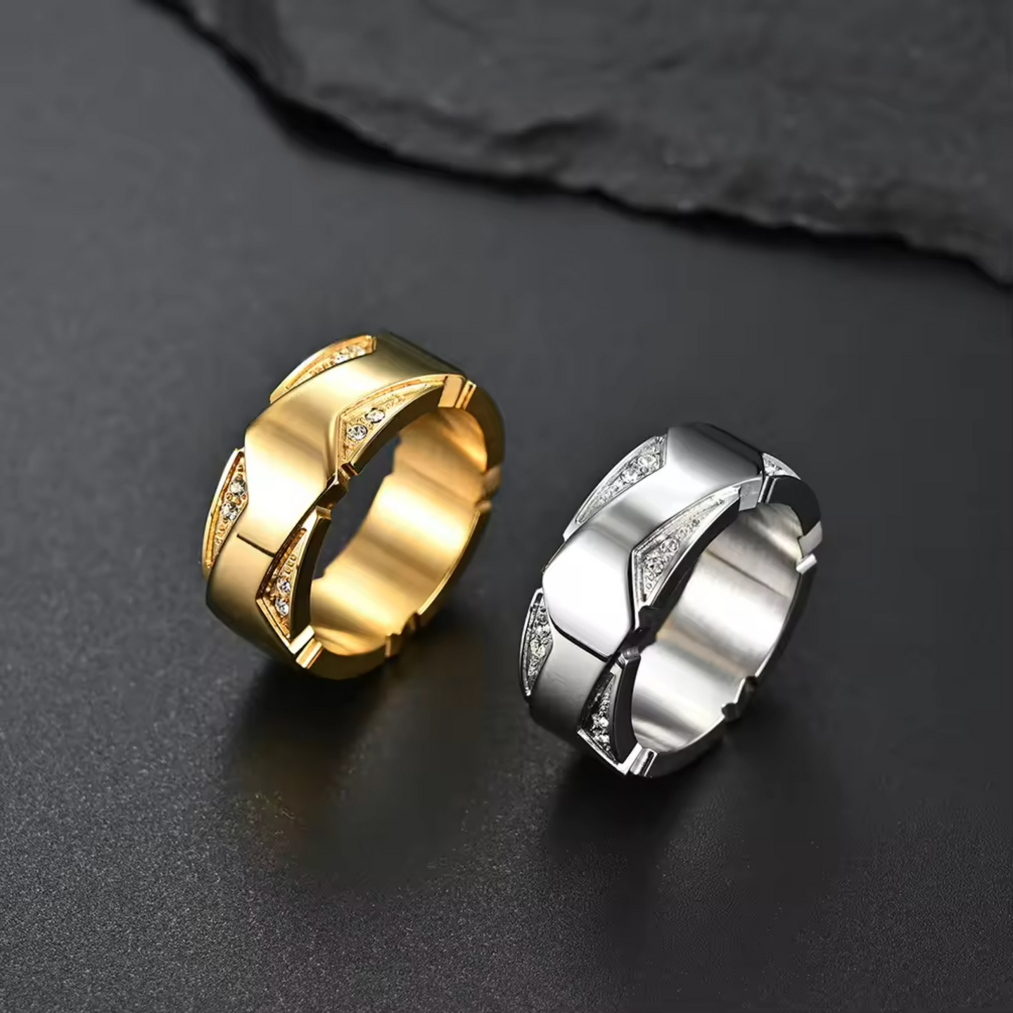 Gold and silver rings on a dark surface