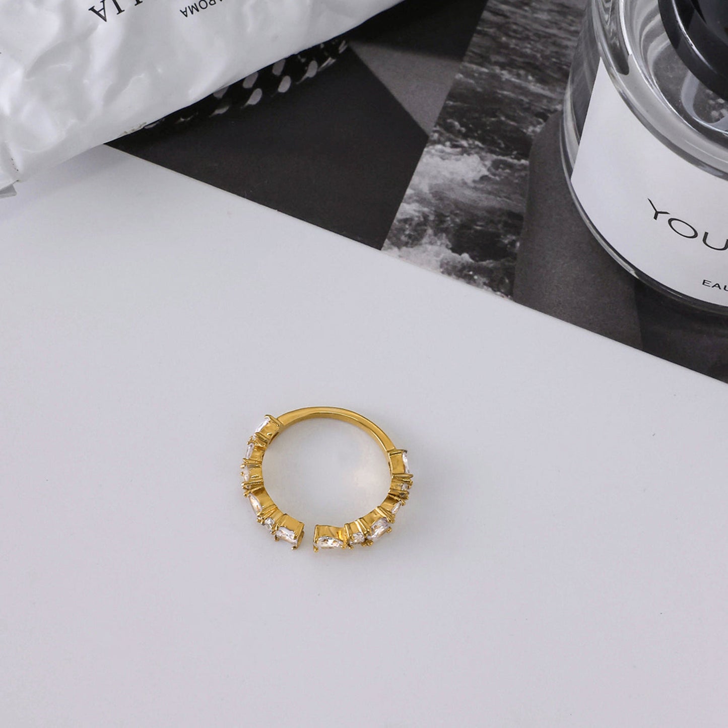 Gold ring with gemstones on a white surface