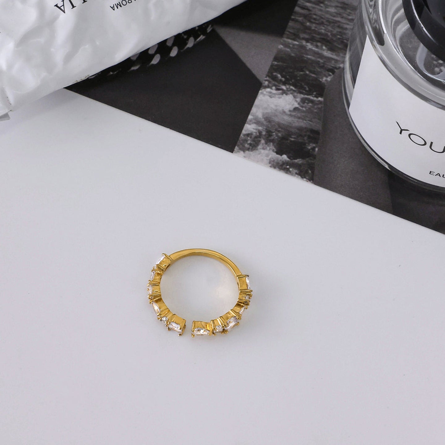 Gold ring with gemstones on a white surface
