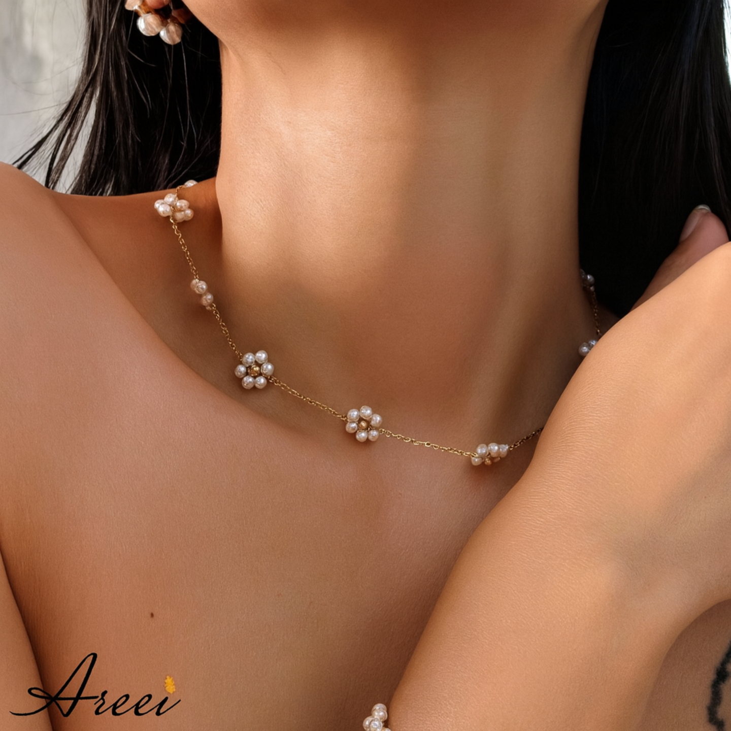 Pearl necklace being worn by a person with a blurred background