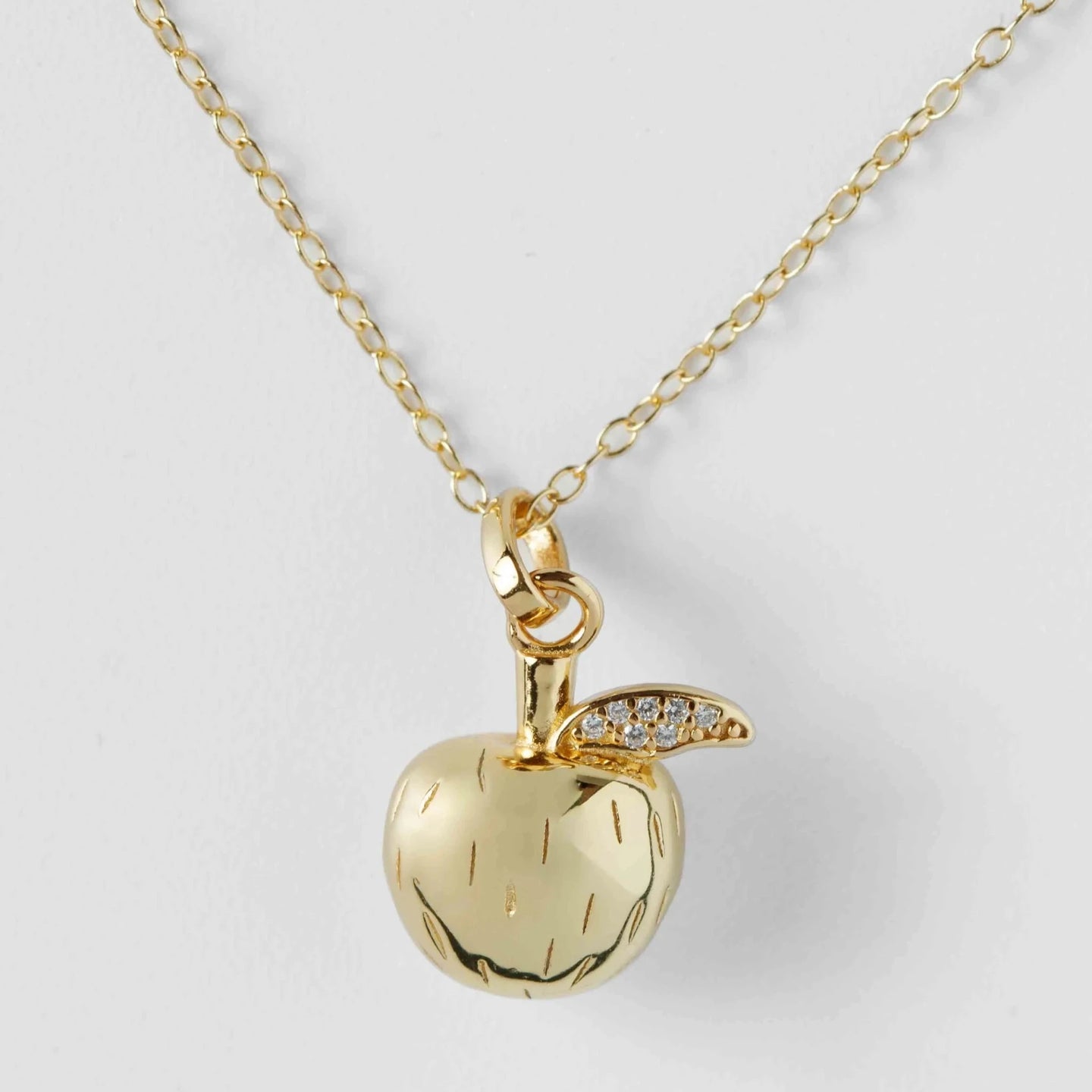 Gold apple necklaace with leaf moisannite diamonds