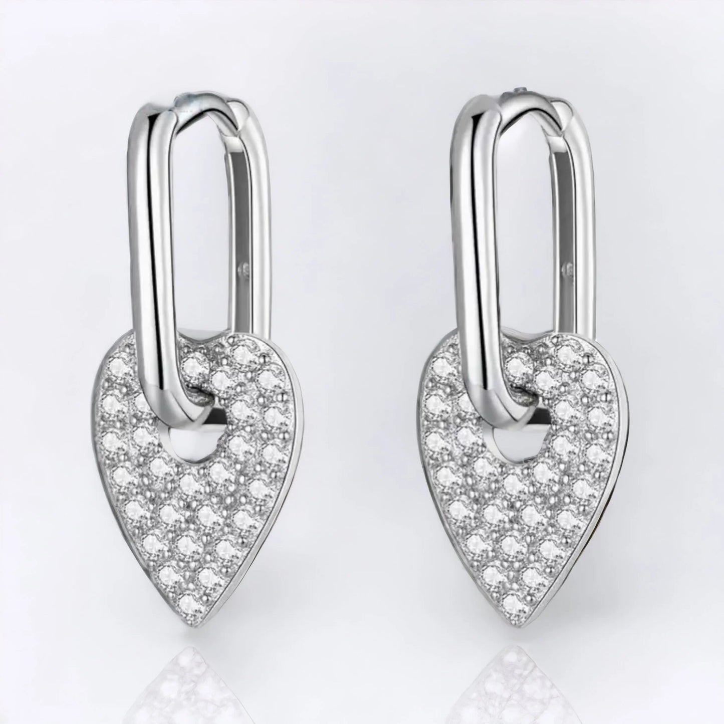 Silver huggie earring with dangling heart zirconia