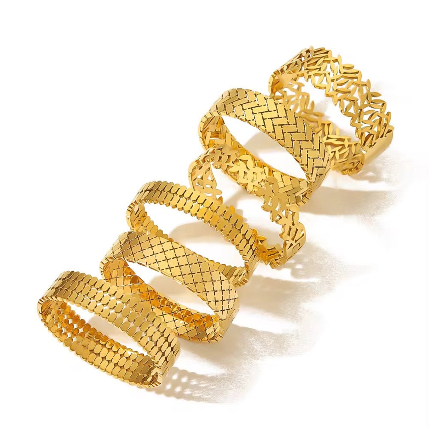 Gold spiral bracelet on a white background