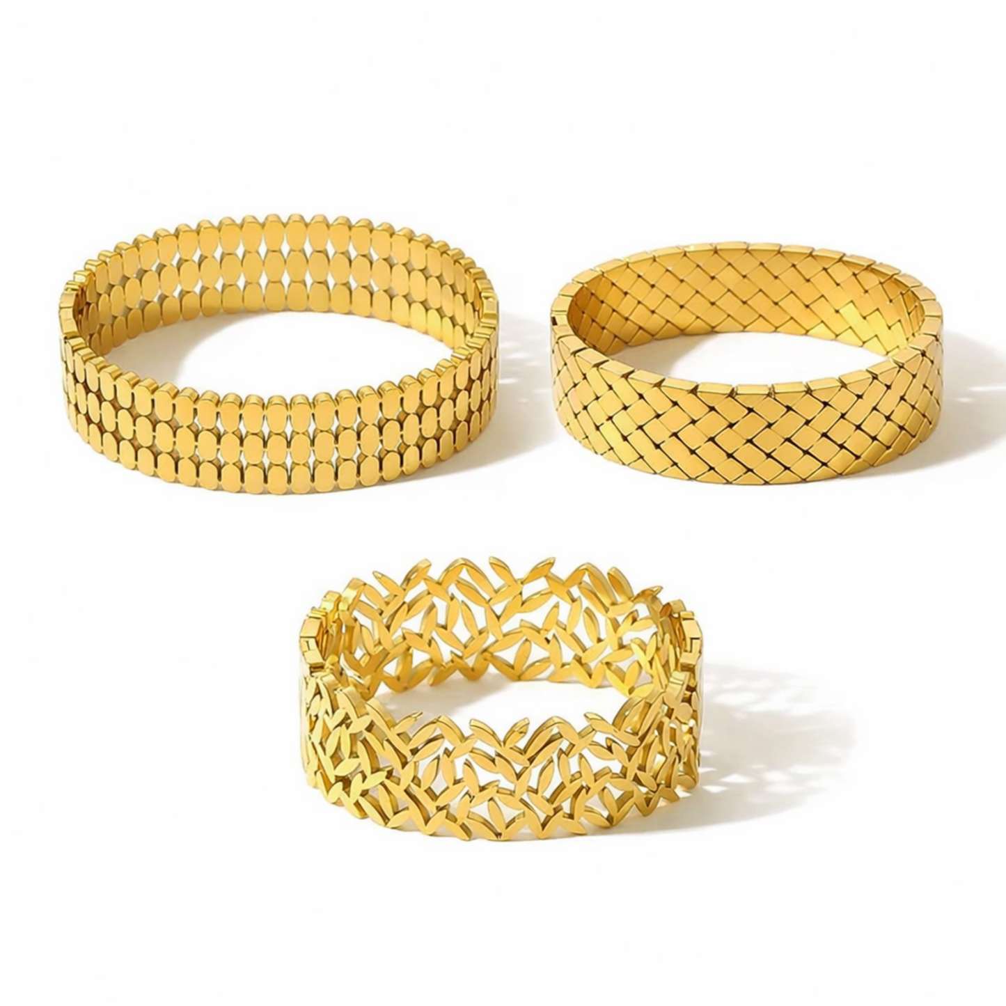 Three gold bracelets with different patterns on a white background