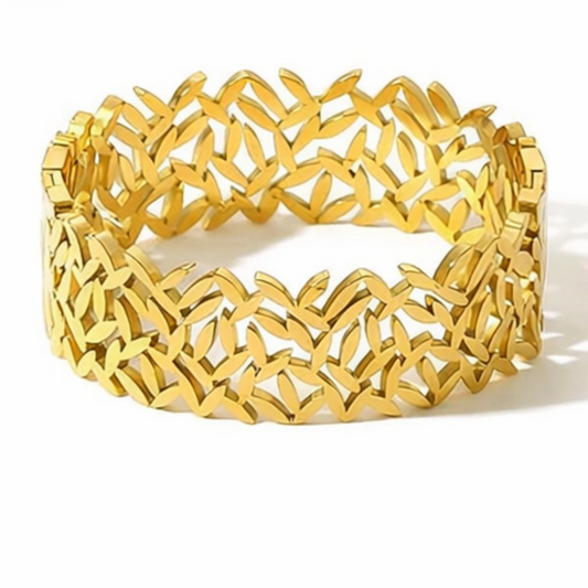 Gold bracelet with intricate design on a white background