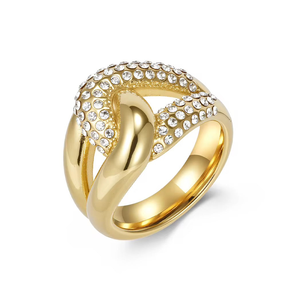 Gold ring with crystal embellishments on a white background