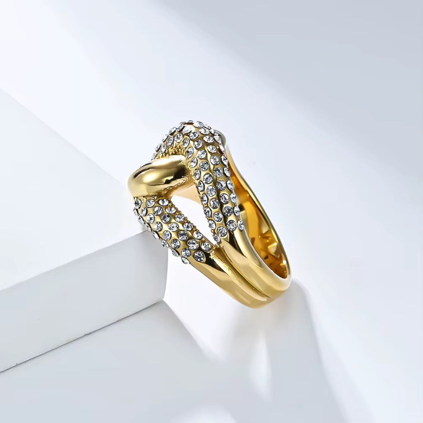 Gold ring with embedded diamonds on a white background