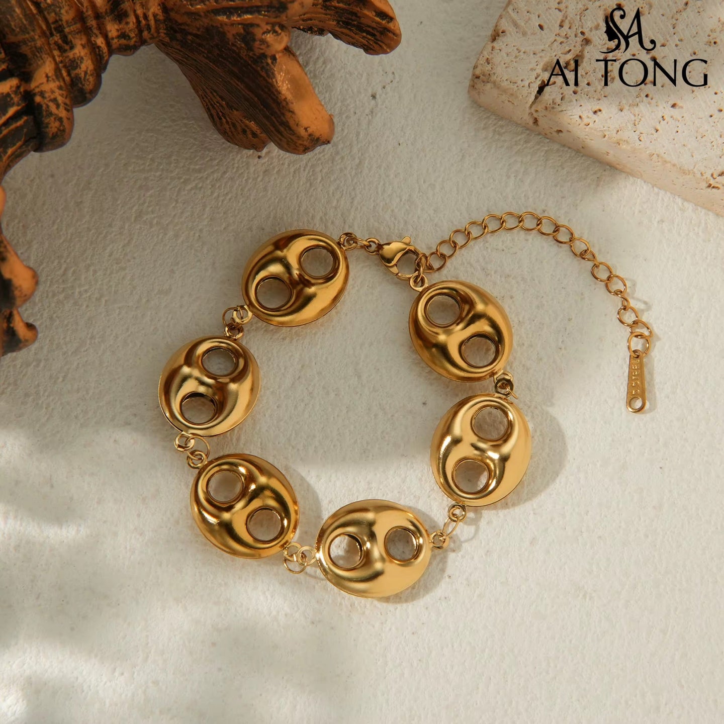 Gold bracelet on a textured surface.