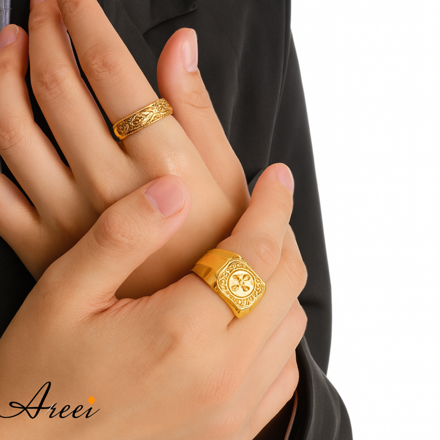 Two hands wearing gold rings with a plain background, featuring the brand 'Areei'.