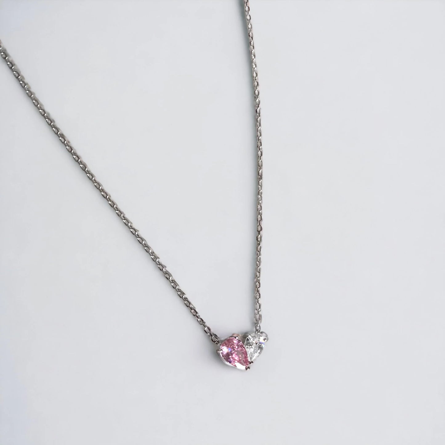 Heart necklace with one half pink zirconia and other white zirconia