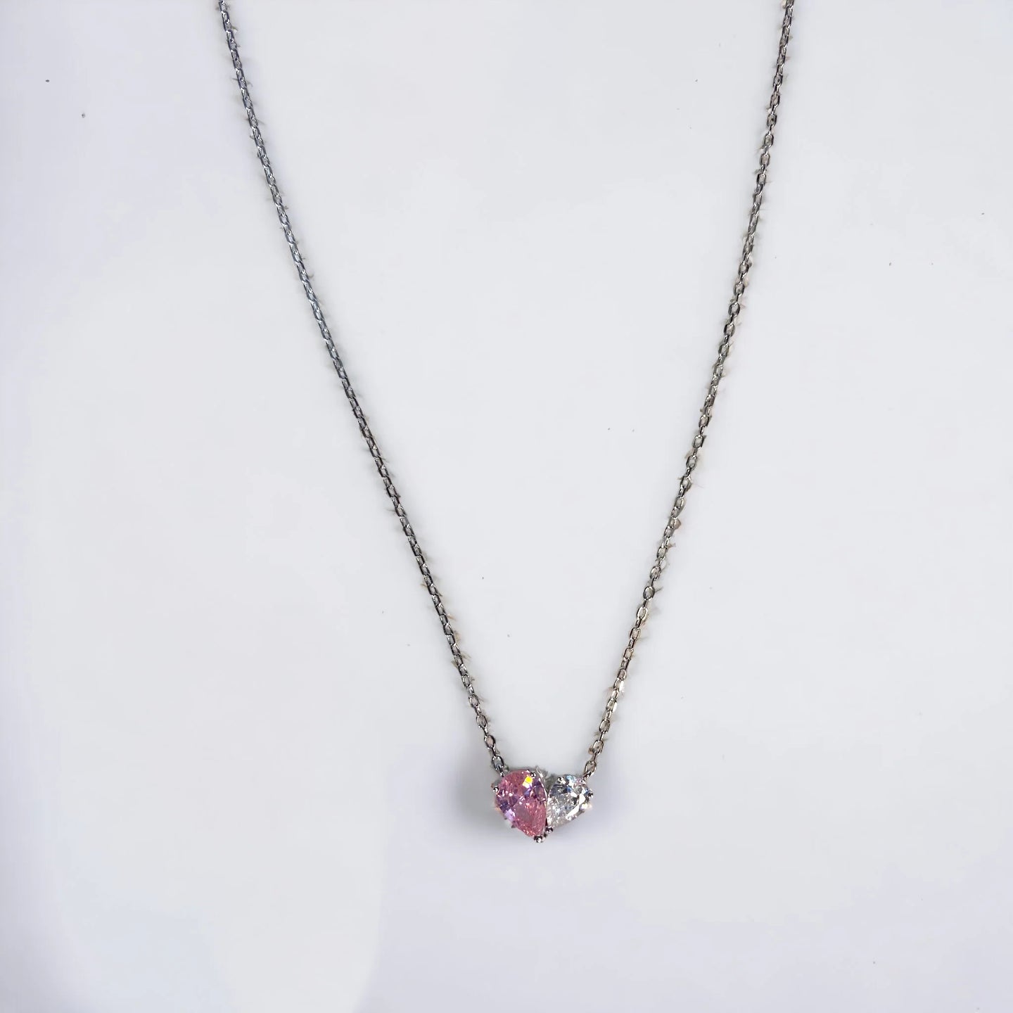 Heart necklace with one half pink zirconia and other white zirconia