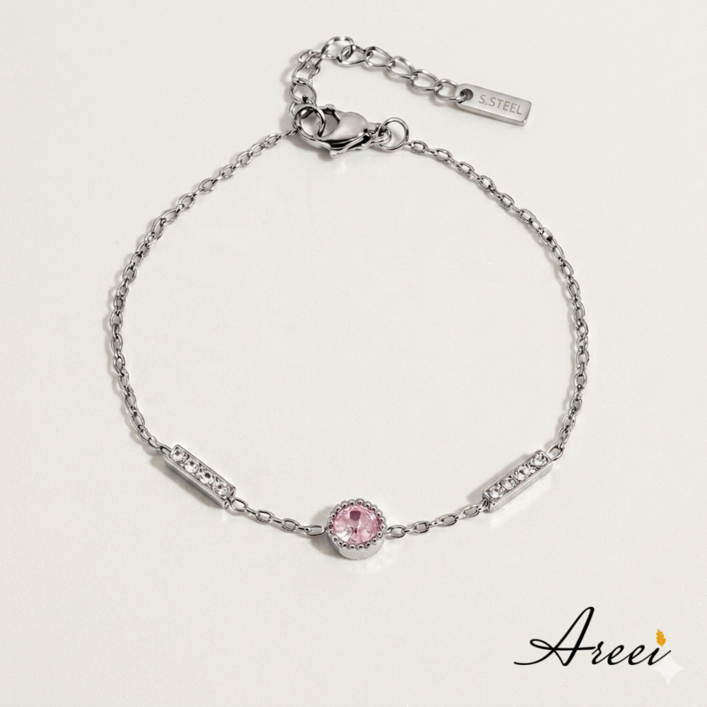 Silver bracelet with a pink gemstone on a light gray background, featuring the brand 'Areei'.