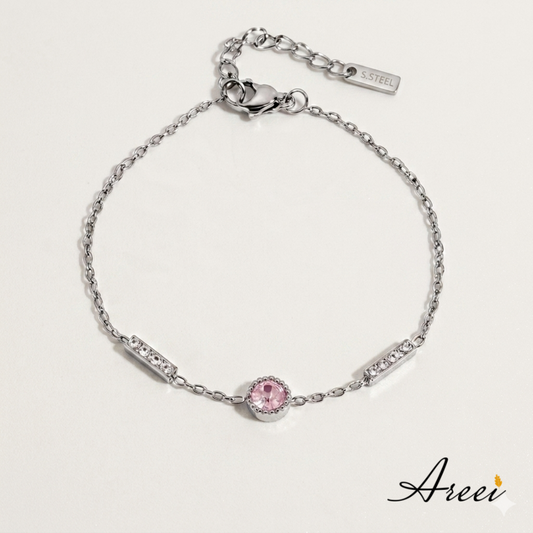 Silver bracelet with a pink gemstone on a light gray background, featuring the brand 'Areei'.