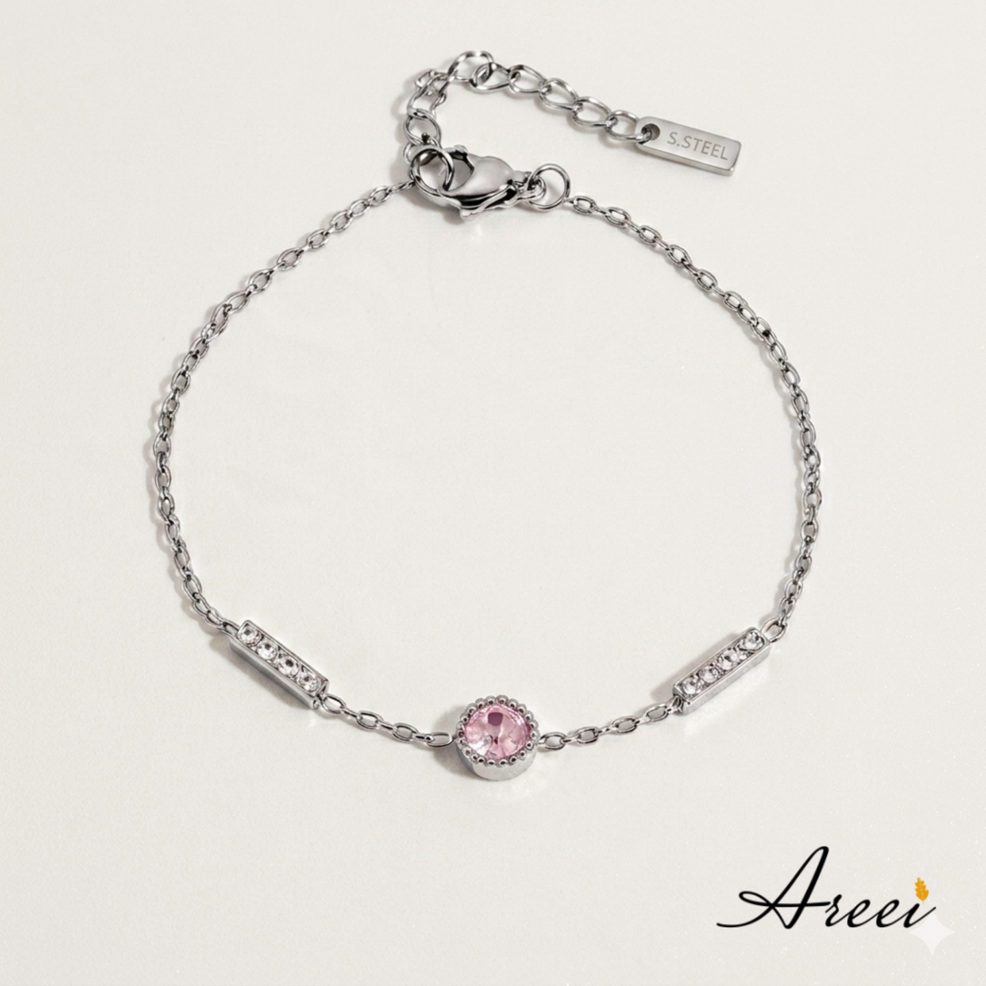 Silver bracelet with a pink gemstone on a light gray background, featuring the brand 'Areei'.
