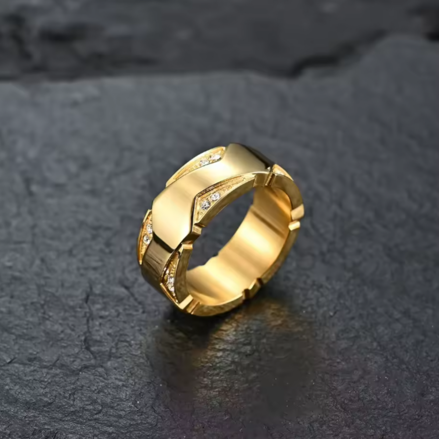 Gold ring with geometric design on a dark textured surface