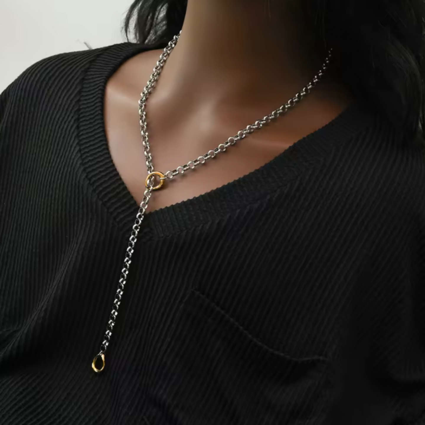 Silver chain necklace on a black sweater
