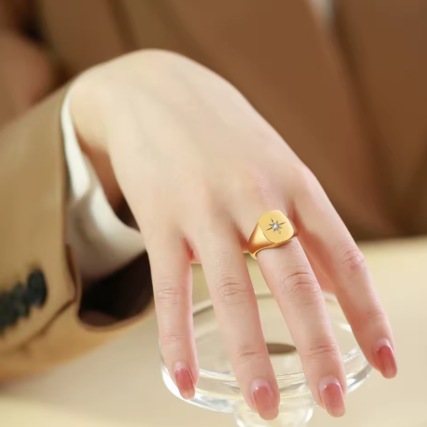 Gold ring on a hand with a blurred background