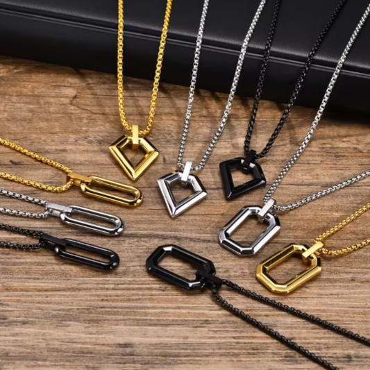 Collection of gold, silver, and black necklaces on a wooden surface
