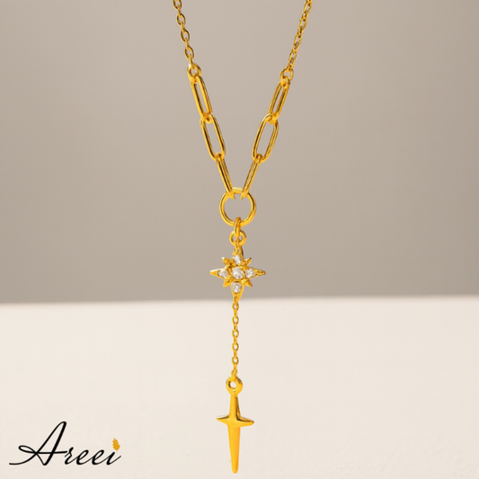 Gold necklace with star and arrow pendant on a neutral background, featuring the brand 'Areei'.