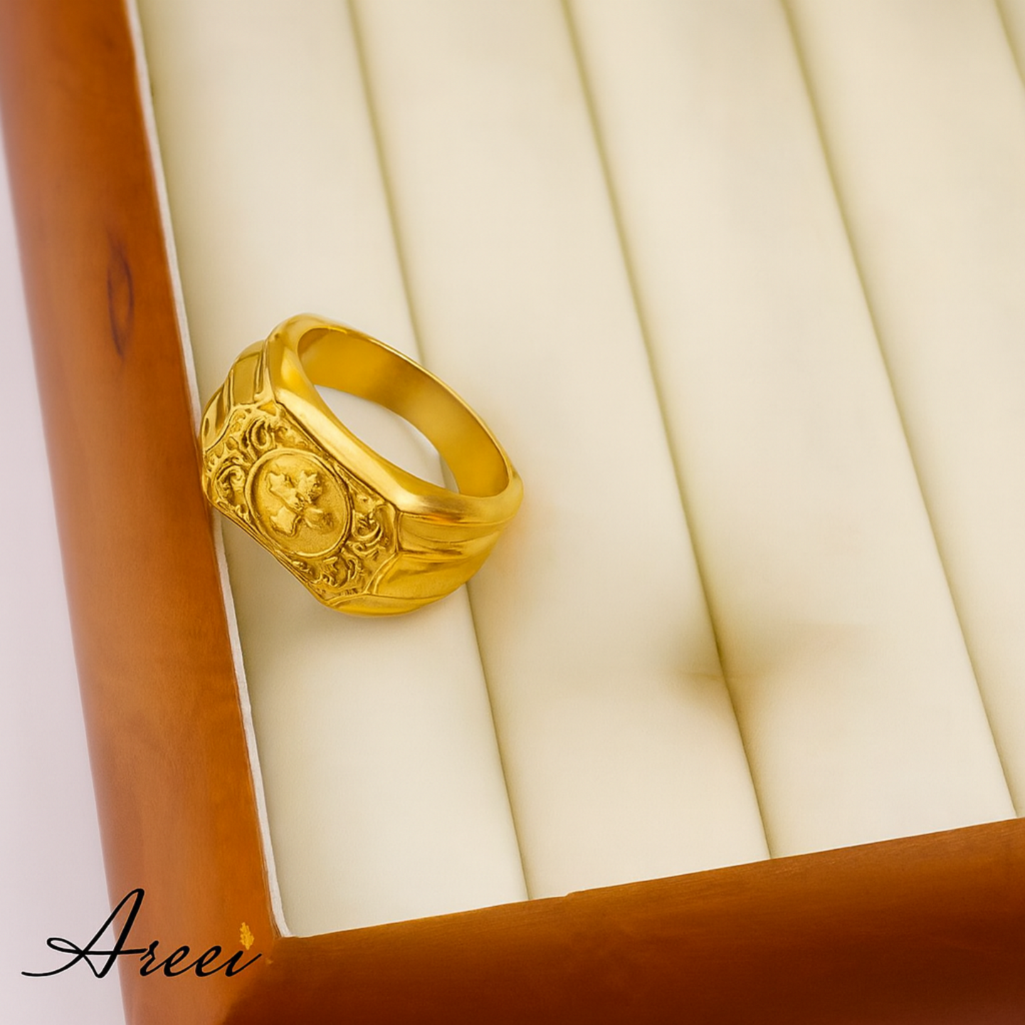 Gold ring with intricate design on a wooden box
