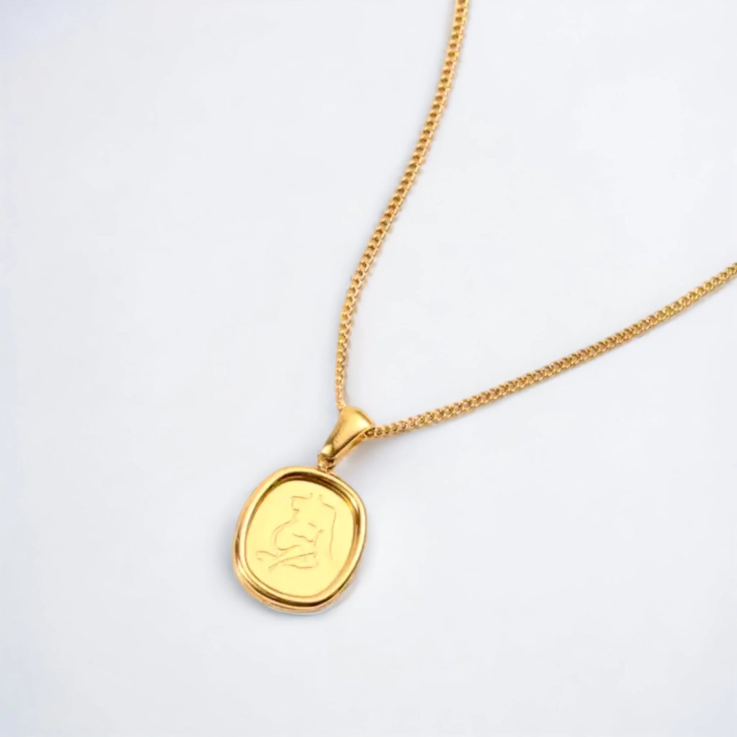 Gold pendant necklace with image of female figure